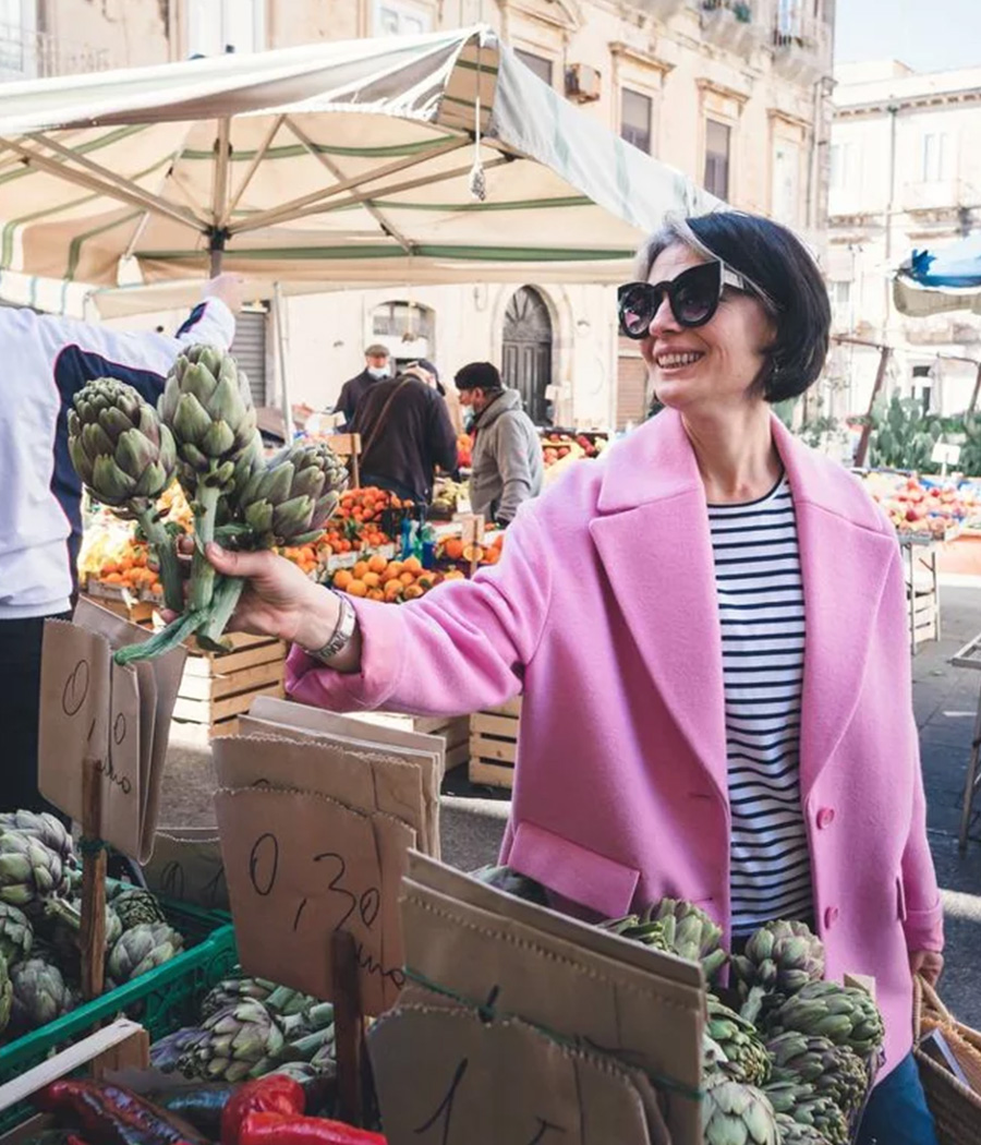 Picture of Pelin Bayer at a local market stall to buy vegetables.